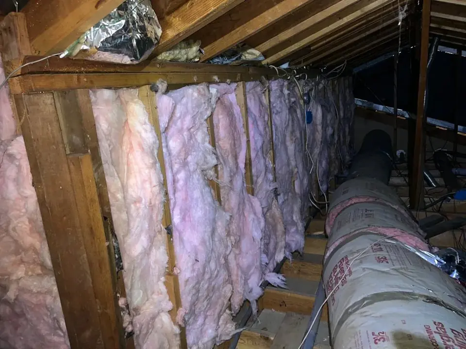 New batt insulation fitted along the framing, beside new insulated ducts