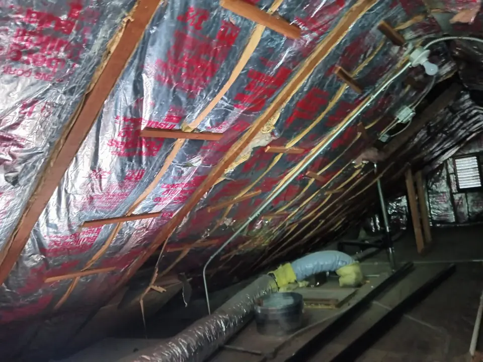 Radiant barrier foil covering the underside of the roof across the attic